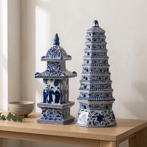Pair of blue and white porcelain pagoda ornaments, both designs, displayed on a pale oak console table