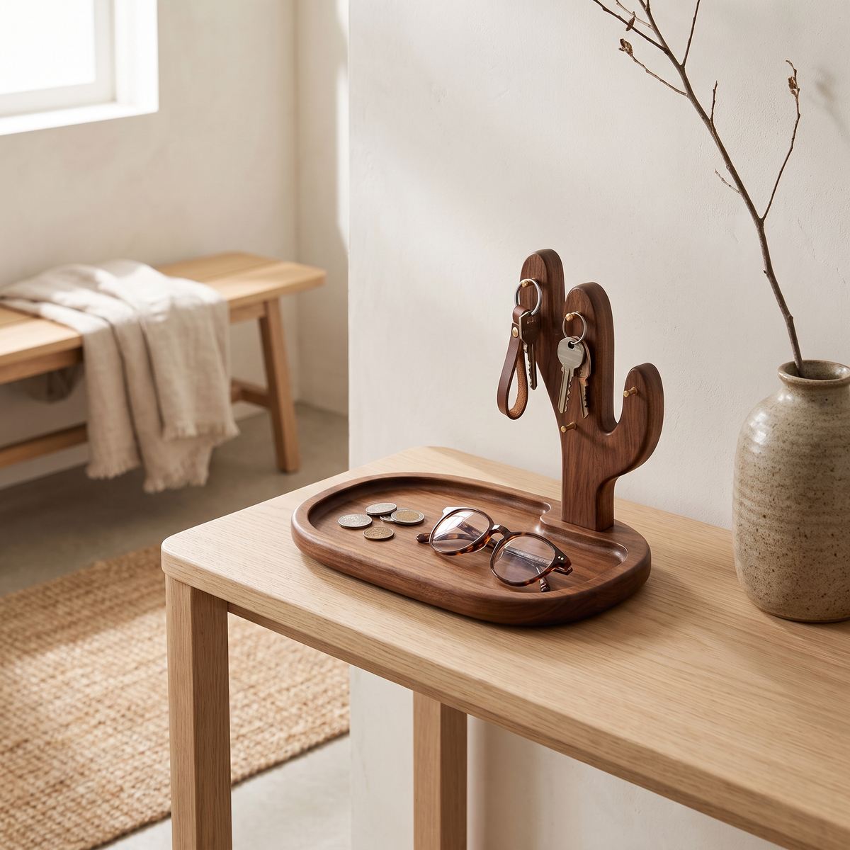 Walnut key tray with cactus key stand on an entryway console