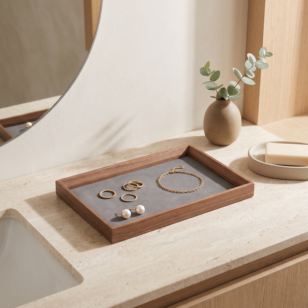 Walnut jewellery display tray with grey insert on a vanity