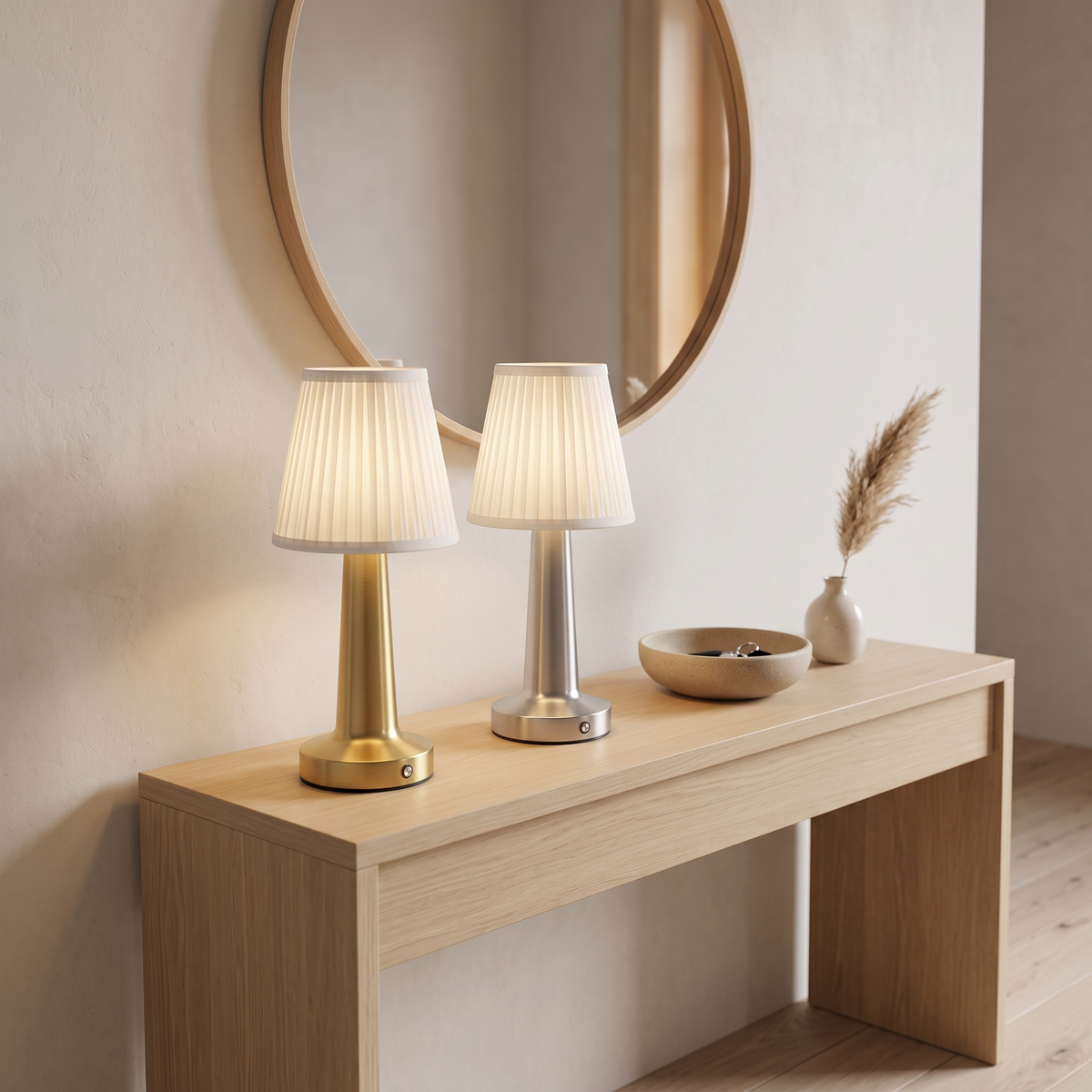 Cordless pleated table lamps in gold and silver on an entryway console