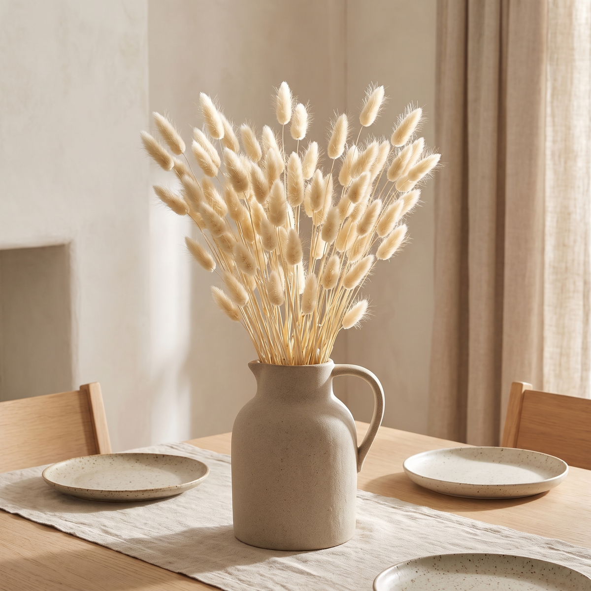 Natural dried bunny tail grass in a stoneware jug on a dining table