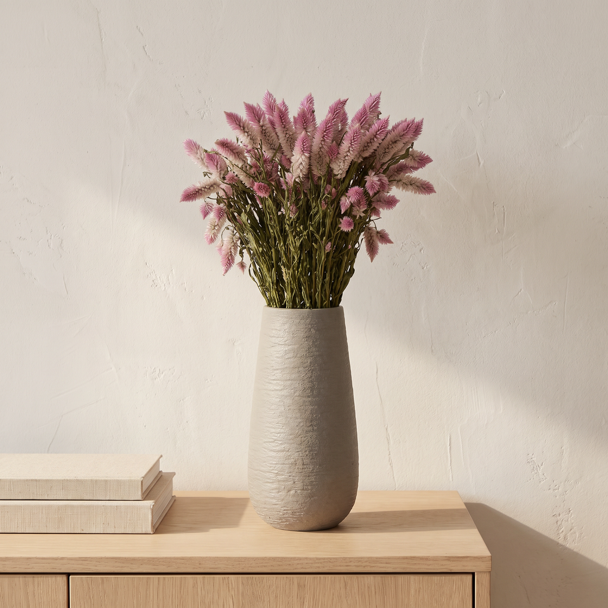 Dried phoenix tail bouquet in a ceramic vase on a sideboard
