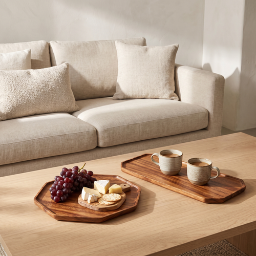 Octagonal and rectangular acacia serving trays on a coffee table