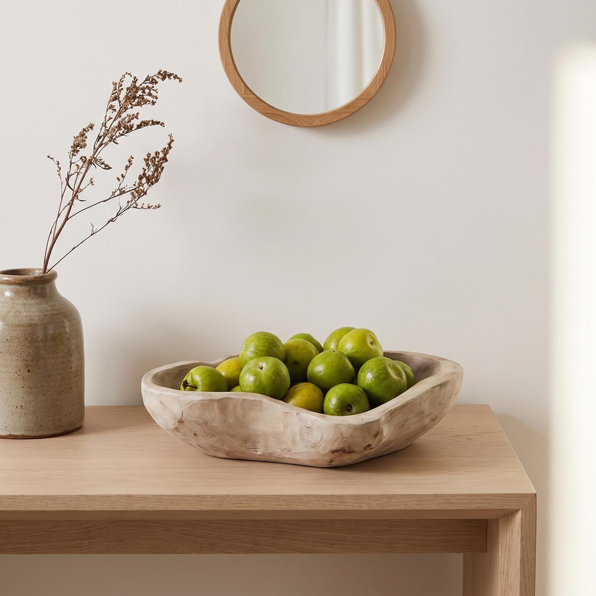 Carved solid wood decorative tray with limes on an entryway console