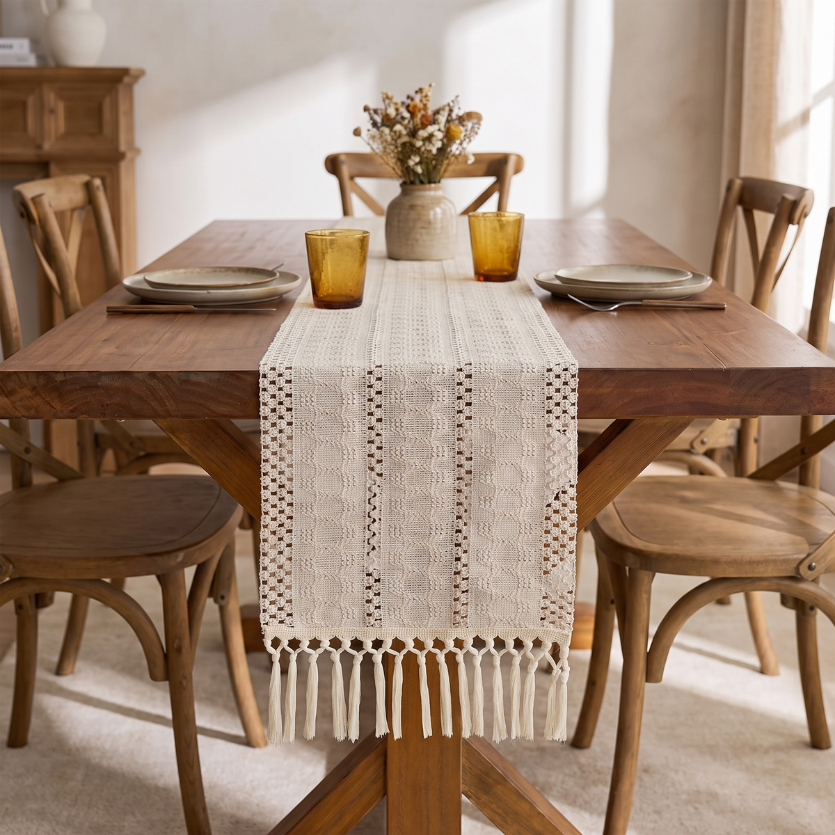 Boho woven table runner with tassels on a wooden dining table