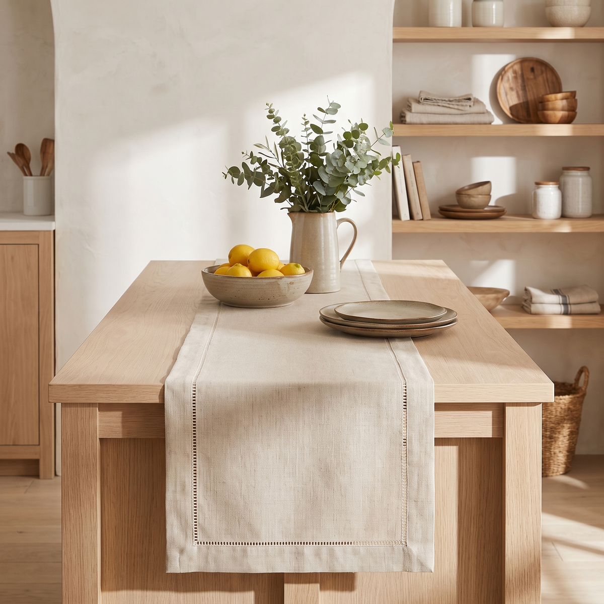 Beige hemstitched linen-look table runner on an oak kitchen island
